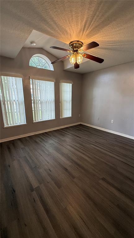 2210 Nicollett Way Leesburg, FL 34748 - Photo 25 of 31 a view of an empty room with wooden floor and a window