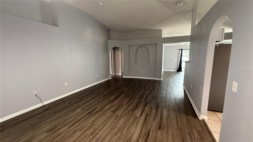 2210 Nicollett Way Leesburg, FL 34748 - Photo 3 of 31 a view of a room with wooden floor