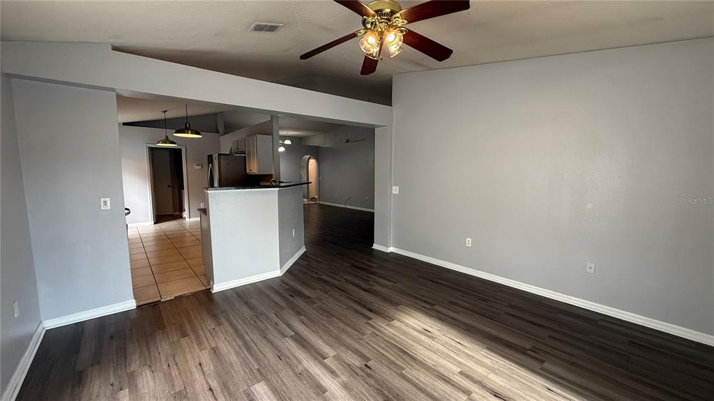 2210 Nicollett Way Leesburg, FL 34748 - Photo 8 of 31 a view of a livingroom with wooden floor