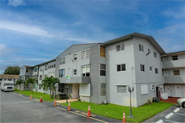 a front view of a building with garden