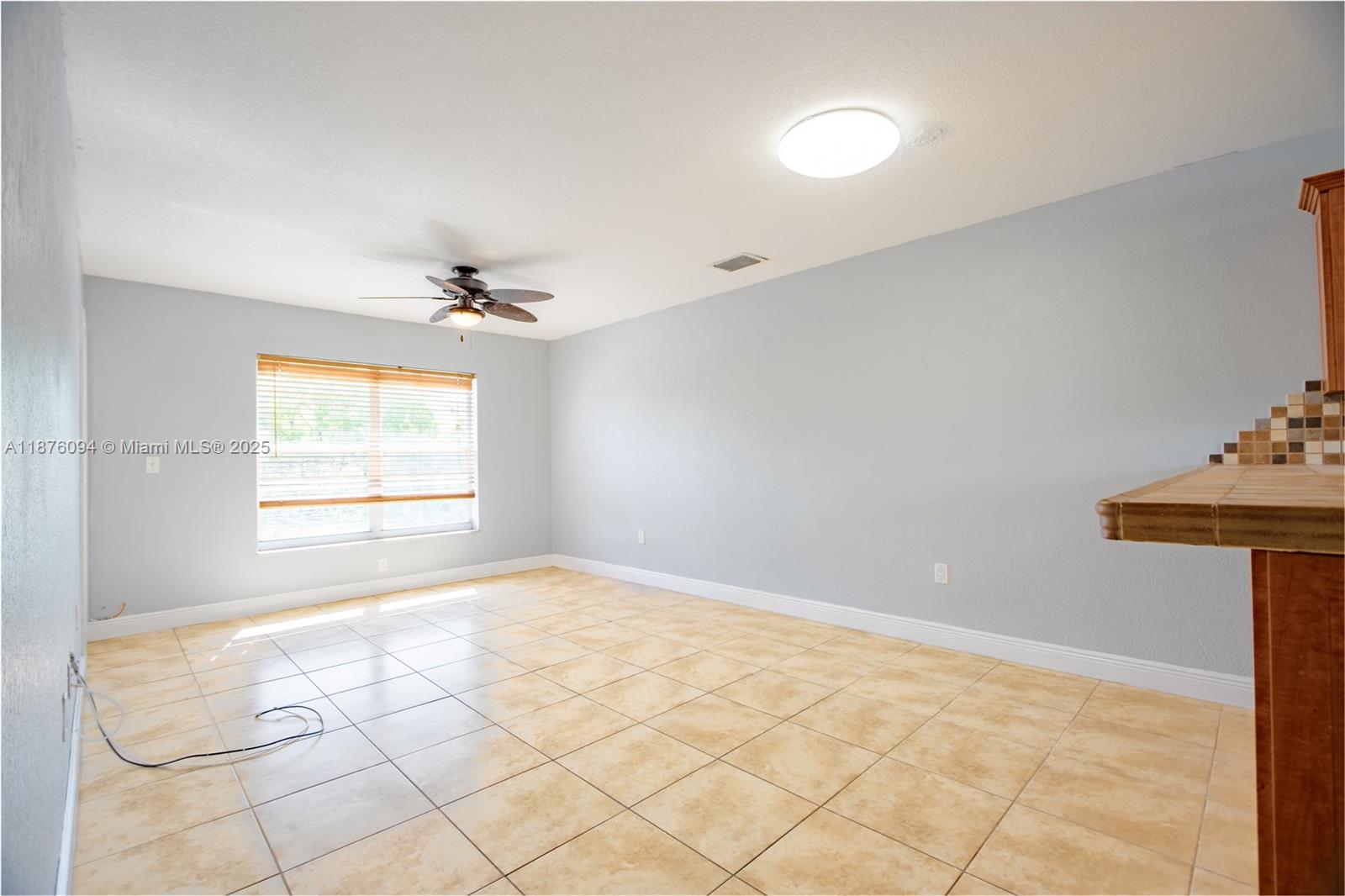 120 Royal Palm Road, Unit 315 Hialeah Gardens, FL 33016 - Photo 4 of 15 a view of an empty room and window