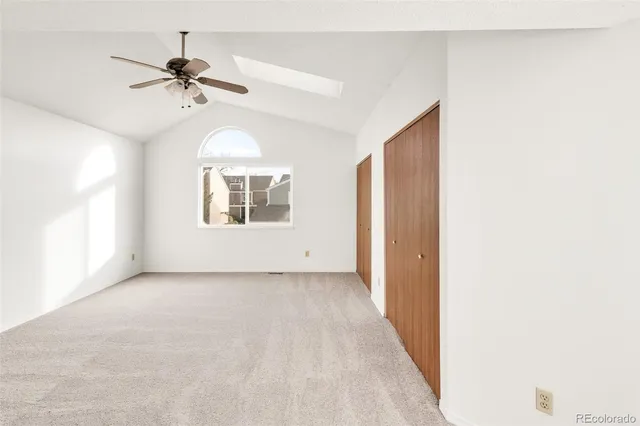 a view of a livingroom with a ceiling fan and window