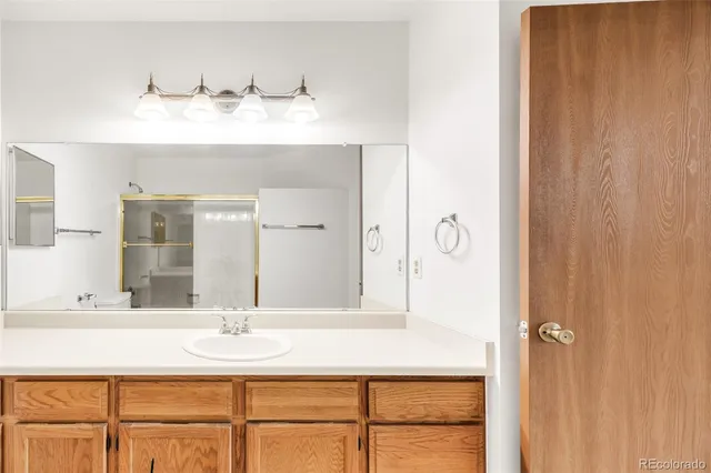 a bathroom with a sink vanity and mirror