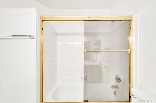 a bathroom with a glass shower door