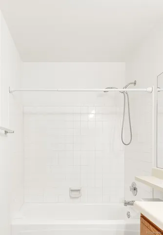 a bathroom with a shower and a bath tub