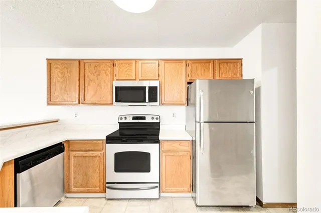 a kitchen with a refrigerator sink and microwave