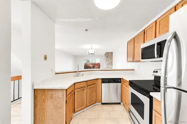 a kitchen with stainless steel appliances granite countertop a sink and a stove