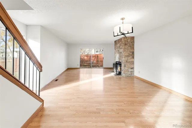 a view of a livingroom with wooden floor and a staircase