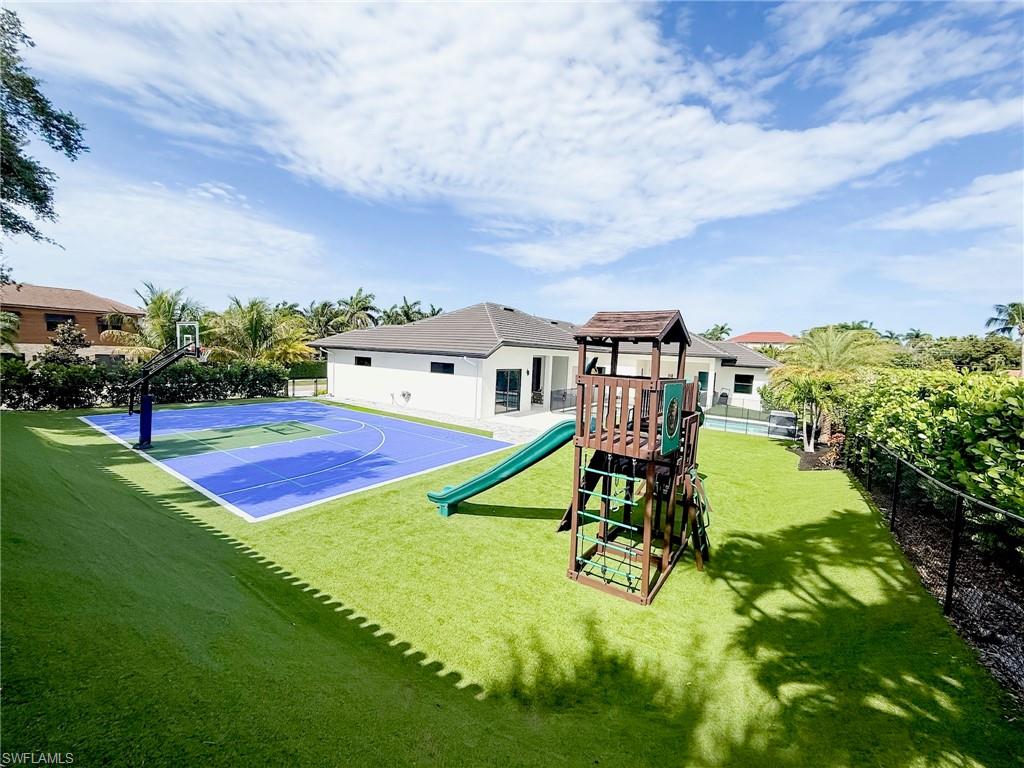 1702 Ludlow Road Marco Island, FL 34145 - Photo 46 of 47 Outdoor multi-sport court with vibrant blue surfacing and kids playground