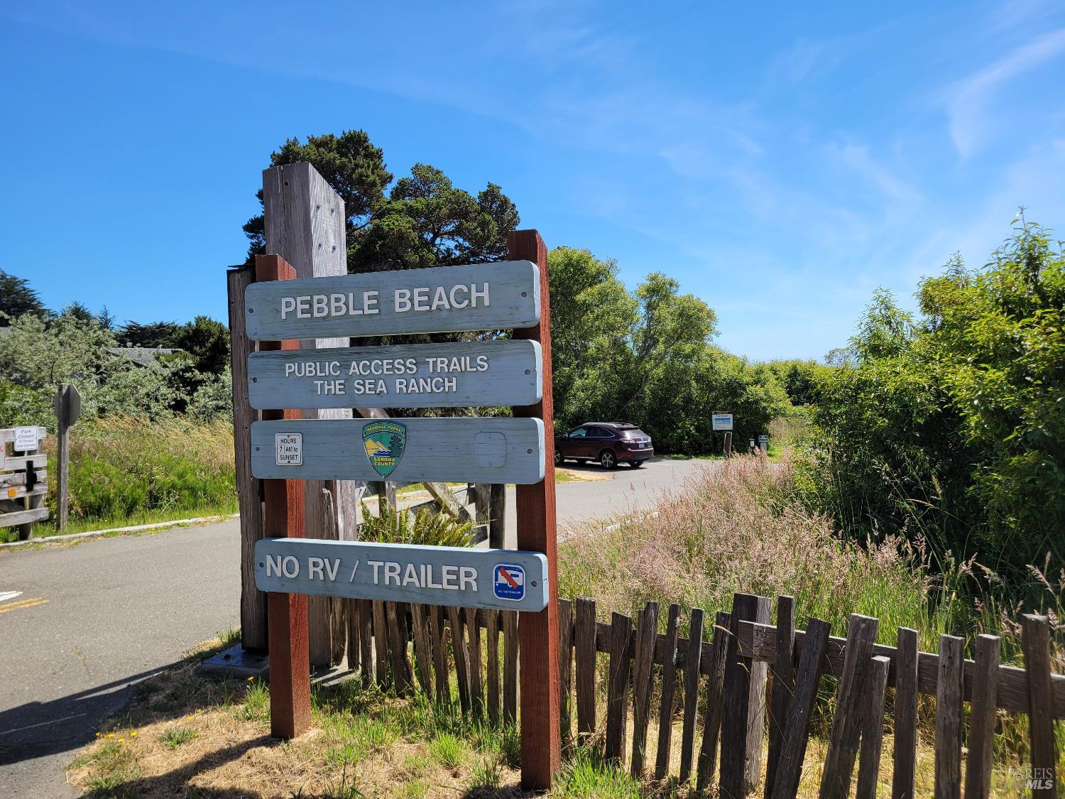 315 Chinquapin Lane The Sea Ranch, CA 95497 - Photo 14 of 18 a view of a brick house with a small yard and wooden fence