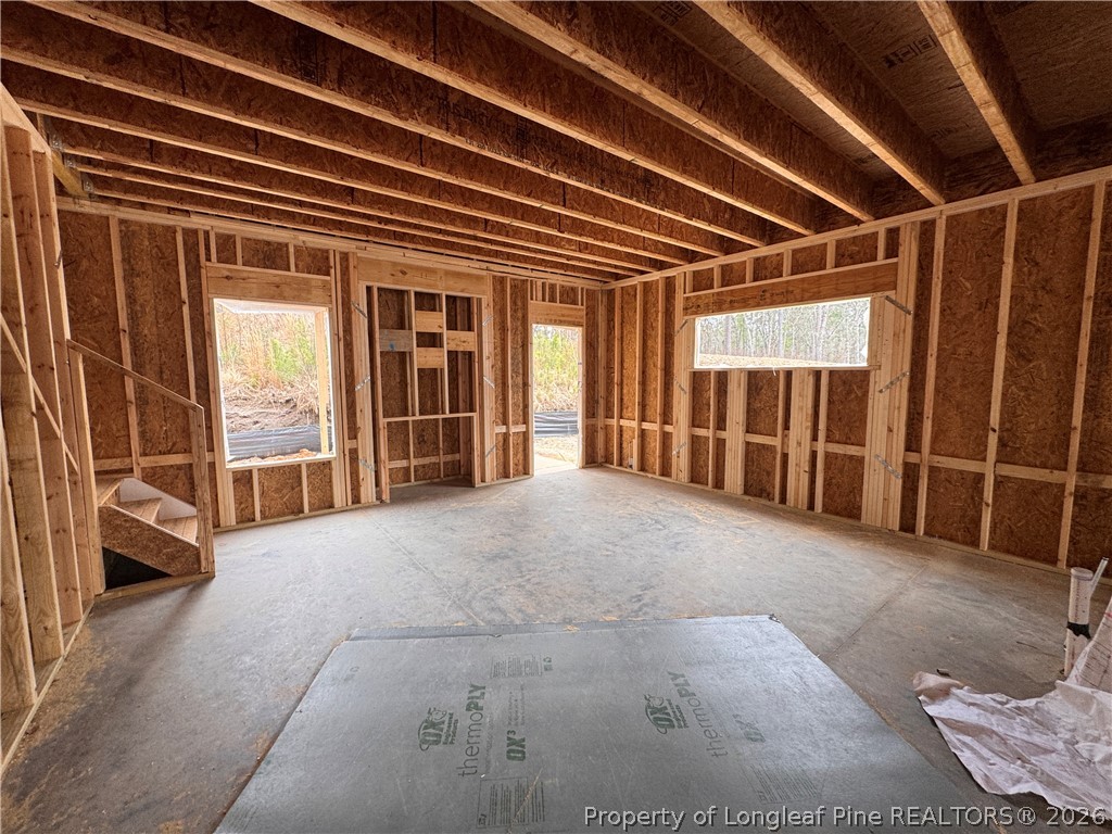 298 Rough Rdg Trail Aberdeen, NC 28315 - Photo 6 of 25 a view of an empty room with wooden floor and a window