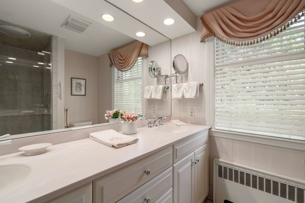 73 Greylock Road Wellesley, MA 02481 - Photo 20 of 26 a bathroom with a sink a mirror and a shower