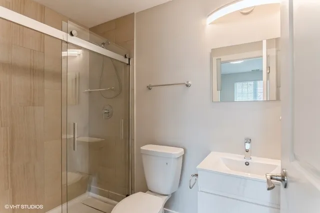 a bathroom with a toilet sink and shower