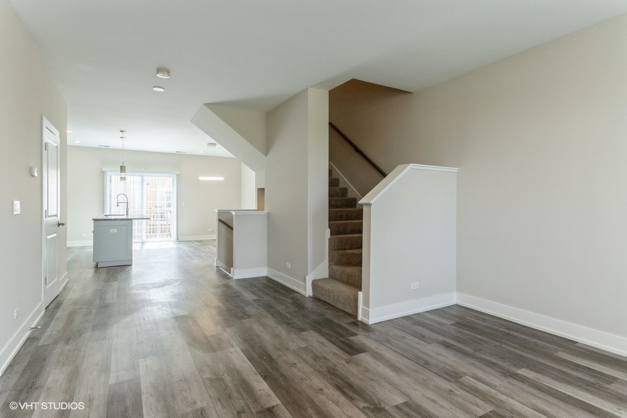 10604 Alice Mae Court Orland Park, IL 60462 - Photo 4 of 14 a view of a hallway with wooden floor and staircase