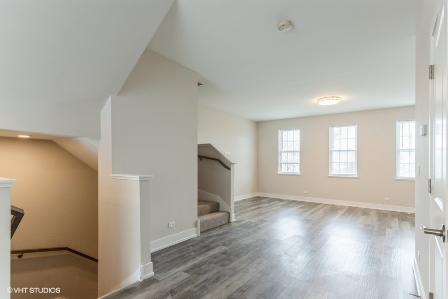 10604 Alice Mae Court Orland Park, IL 60462 - Photo 5 of 14 a view of empty room with wooden floor and fan