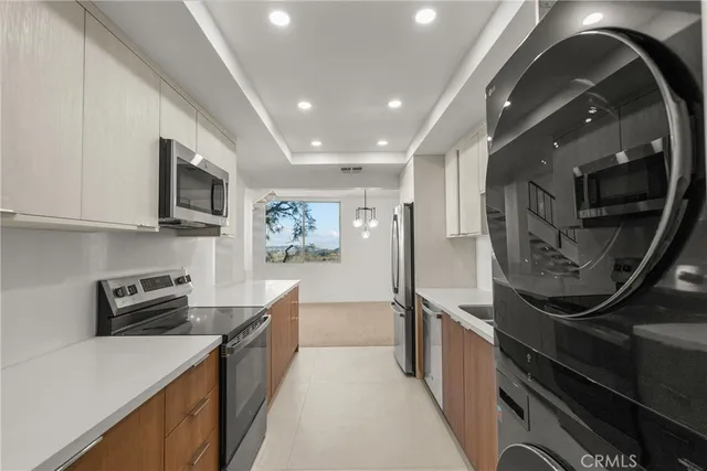 a kitchen with stainless steel appliances a sink stove and cabinets