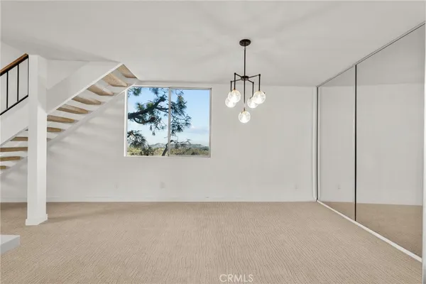 a view of a hallway with a chandelier