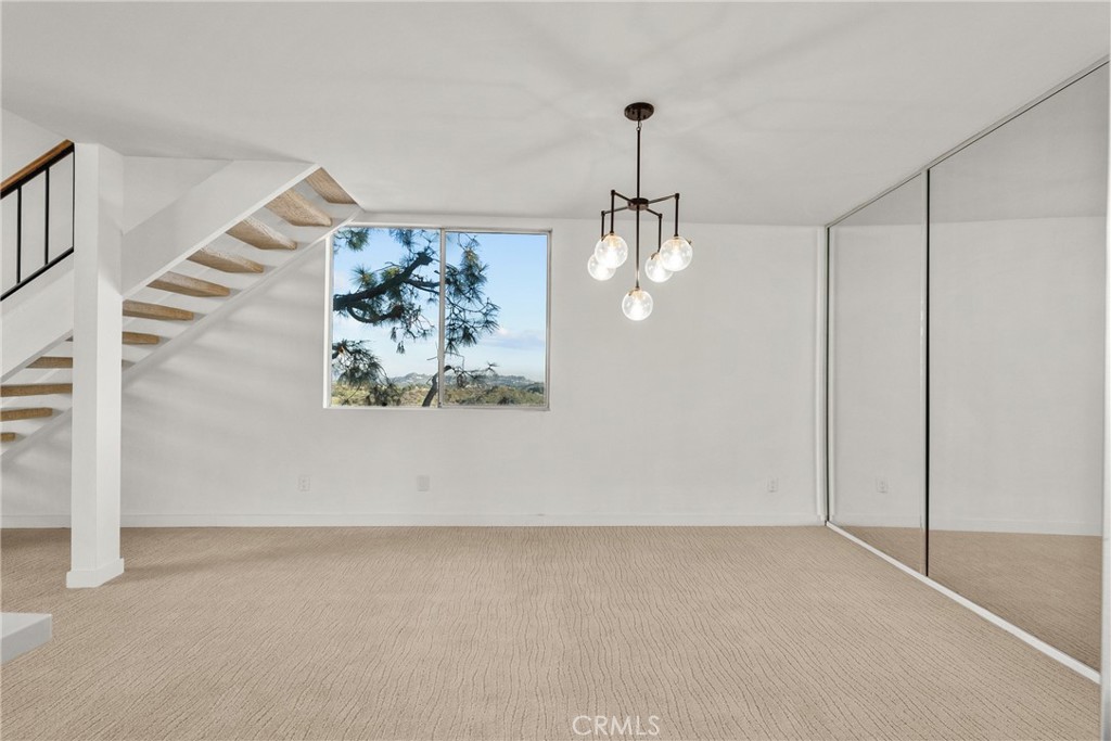 2385 Roscomare Road, Unit F16 Los Angeles, CA 90077 - Photo 13 of 39 a view of a hallway with a chandelier
