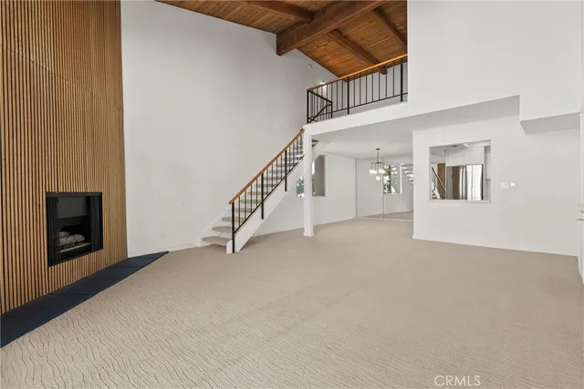 a view of a livingroom with an empty space and a fireplace