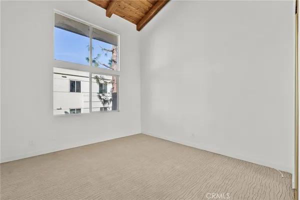 an empty room with a fireplace and wooden floor