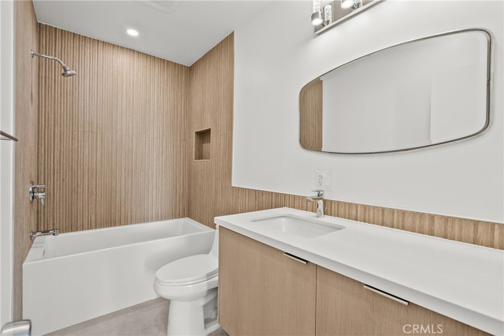 2385 Roscomare Road, Unit F16 Los Angeles, CA 90077 - Photo 23 of 39 a bathroom with a sink a toilet and a mirror