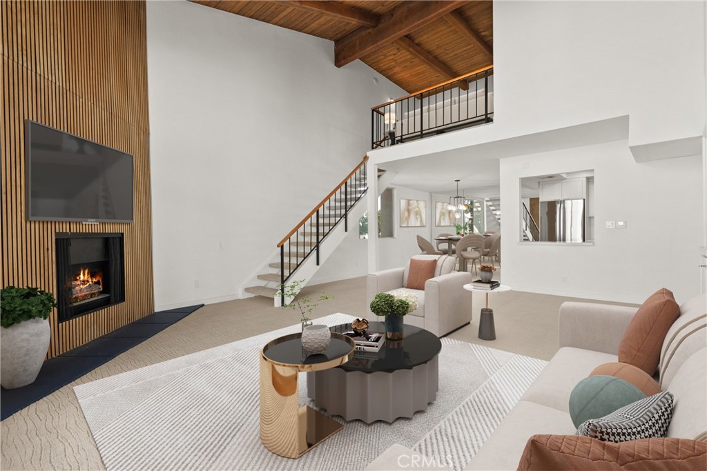 2385 Roscomare Road, Unit F16 Los Angeles, CA 90077 - Photo 3 of 40 a living room with furniture and a fireplace