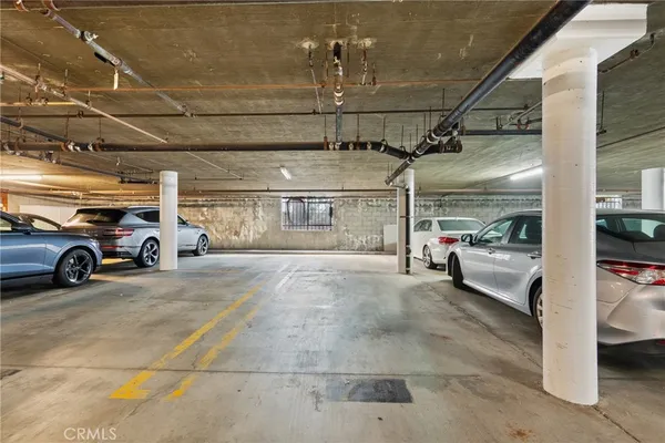 a view of parking garage with cars parked