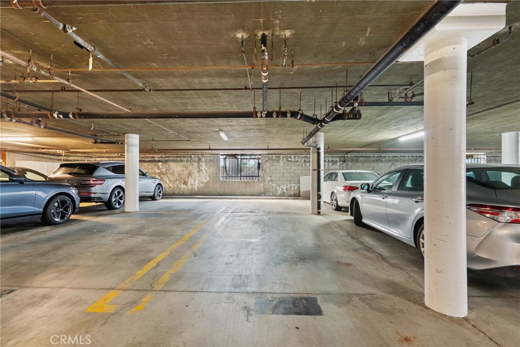 2385 Roscomare Road, Unit F16 Los Angeles, CA 90077 - Photo 34 of 39 a view of parking garage with cars parked