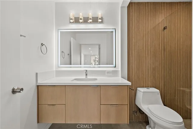 a bathroom with a sink a toilet and mirror