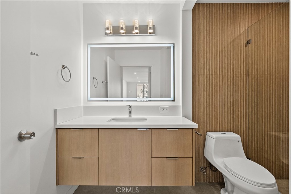 2385 Roscomare Road, Unit F16 Los Angeles, CA 90077 - Photo 9 of 40 a bathroom with a sink a toilet and mirror
