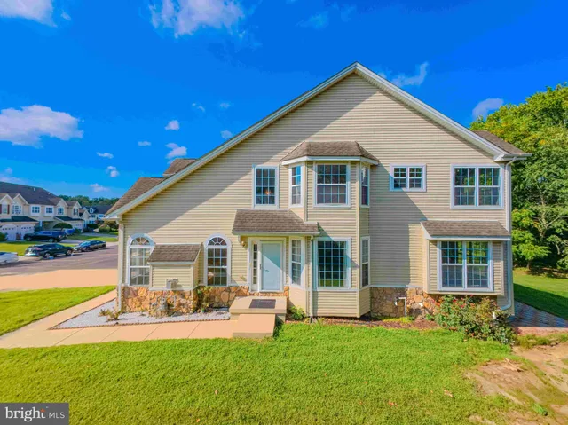 a front view of a house with swimming pool and sitting area