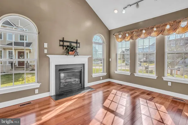 a view of an empty room with window and fire place