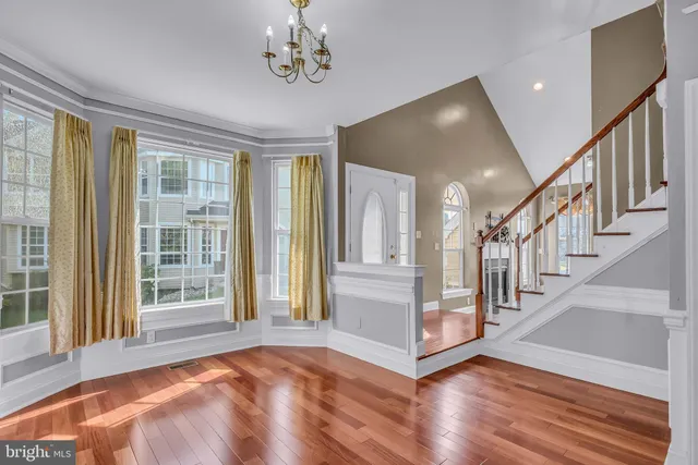 a view of an entryway with wooden floor and windows