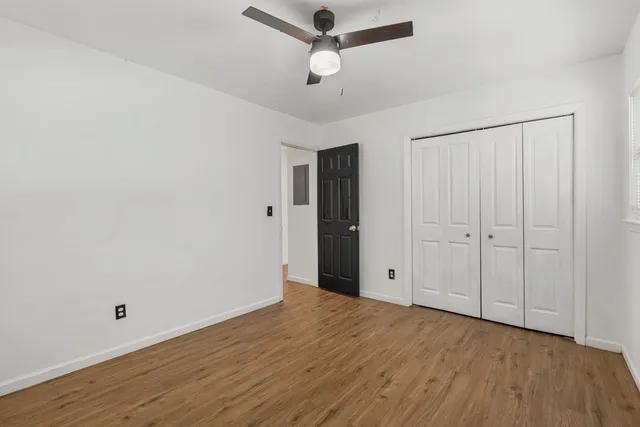a view of empty room with wooden floor