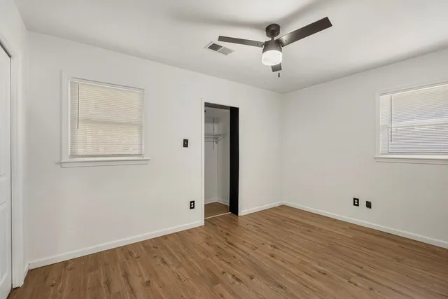 a view of an empty room with wooden floor