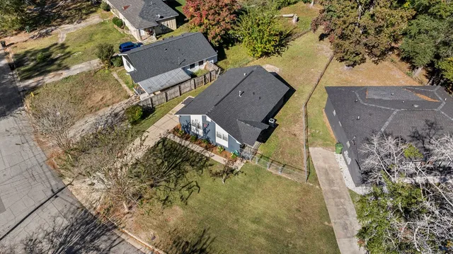 an aerial view of a house with a yard