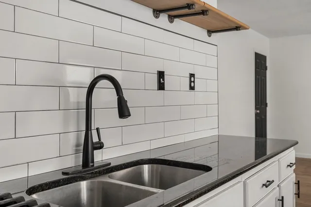 a kitchen with stainless steel appliances granite countertop a stove and a sink