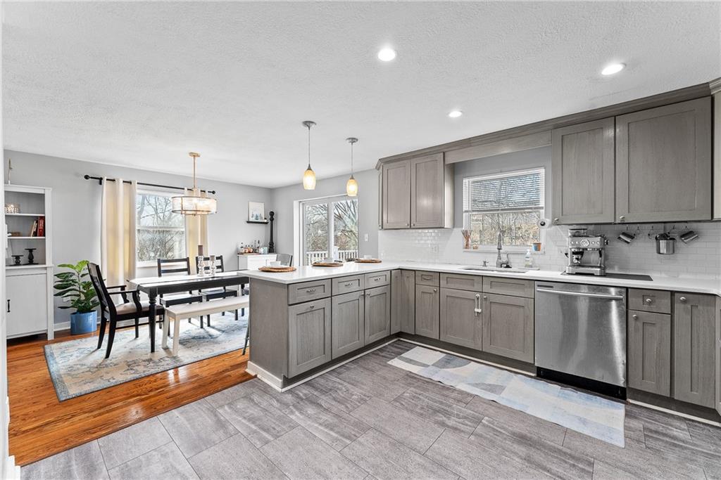 5670 Library Road Bethel Park, PA 15102 - Photo 15 of 49 The kitchen is a chef’s dream, featuring sleek quartz countertops, an open-concept design, a gas stove, and plenty of space for meal prep and cooking.