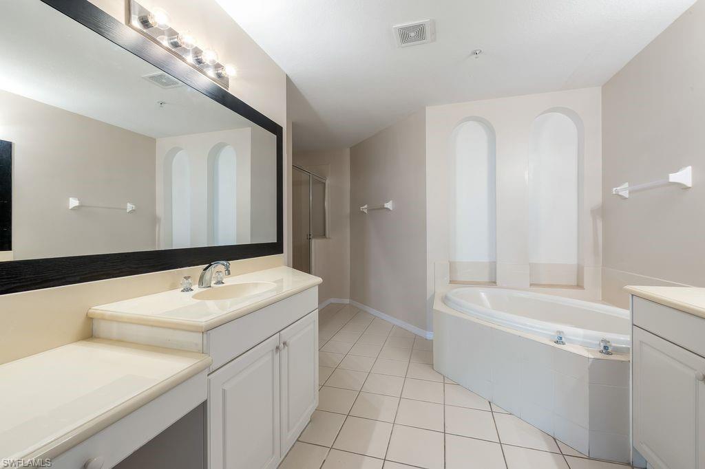 3610 Lansing Loop, Unit 103 Estero, FL 33928 - Photo 18 of 30 Large Soaking Tub and Shower with seat.