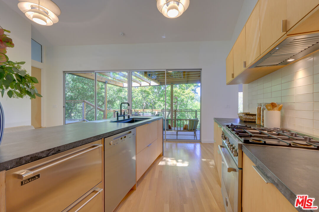 1847 Calgary Lane Los Angeles, CA 90077 - Photo 12 of 43 a kitchen with stainless steel appliances granite countertop a stove a sink and a refrigerator