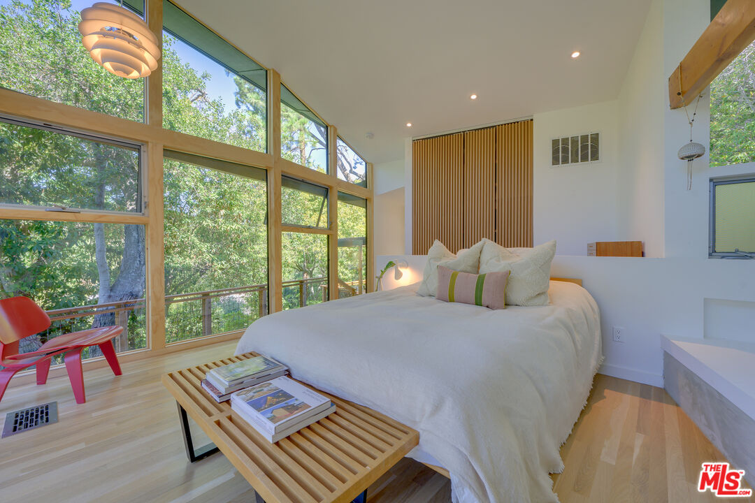 1847 Calgary Lane Los Angeles, CA 90077 - Photo 23 of 43 a bed sitting in a bedroom next to a window