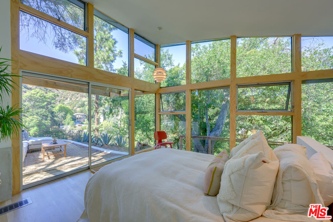 1847 Calgary Lane Los Angeles, CA 90077 - Photo 25 of 43 a bed sitting in a bedroom next to a large window