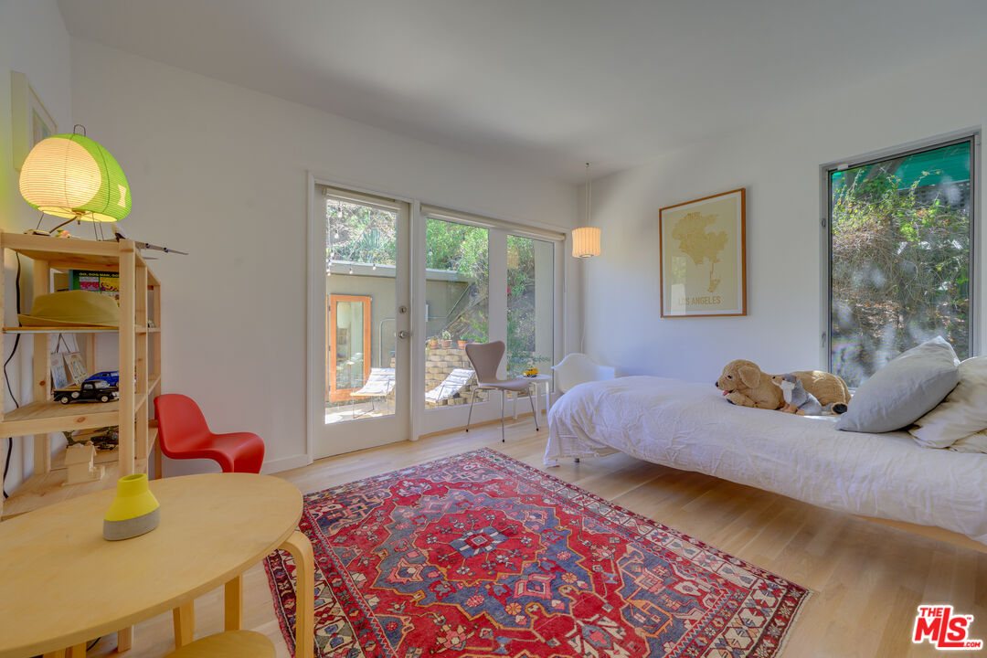 1847 Calgary Lane Los Angeles, CA 90077 - Photo 36 of 43 a bedroom with a bed and large windows