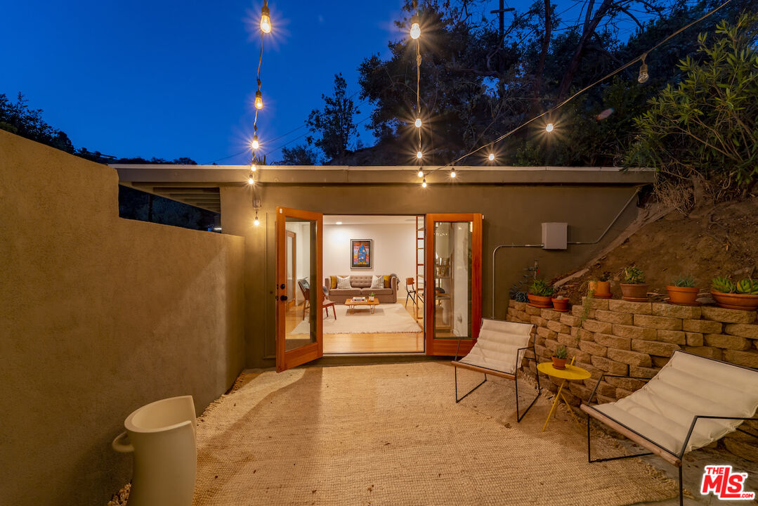 1847 Calgary Lane Los Angeles, CA 90077 - Photo 39 of 43 a view of a patio with table and chairs with wooden floor and fence
