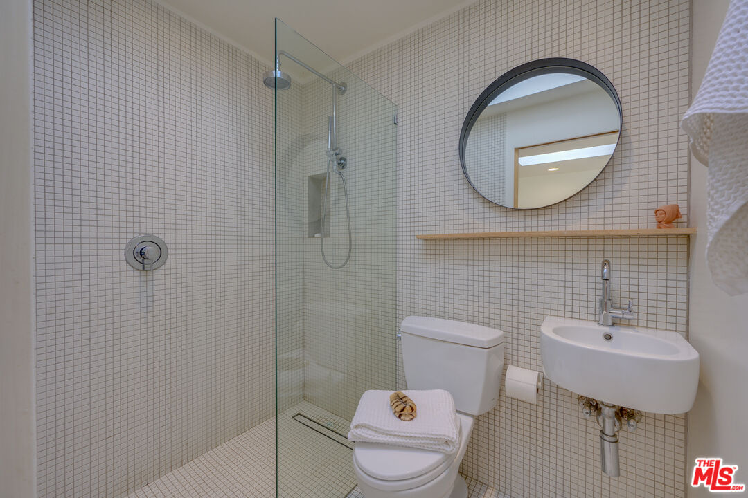 1847 Calgary Lane Los Angeles, CA 90077 - Photo 42 of 43 a bathroom with a toilet sink and mirror