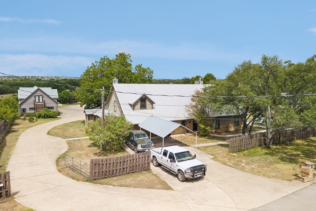 10111 Signal Hill Road Austin, TX 78737 - Photo 34 of 40 A long paved driveway leads past mature trees to this rustic multi-level countryside residence.