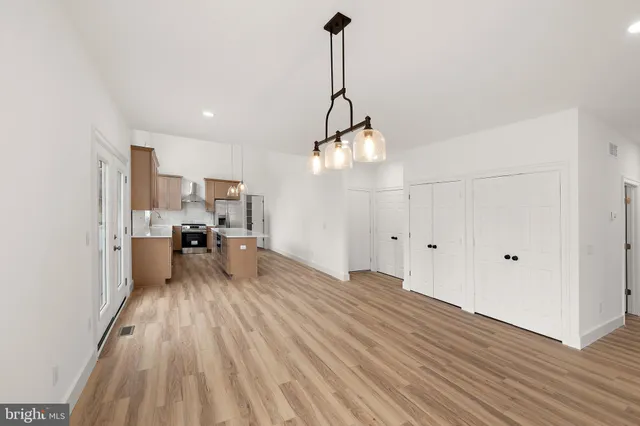 a bedroom with a bed potted plant with the wooden floor