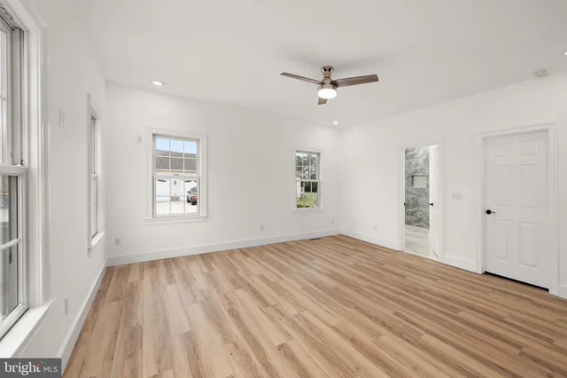a view of empty room with wooden floor