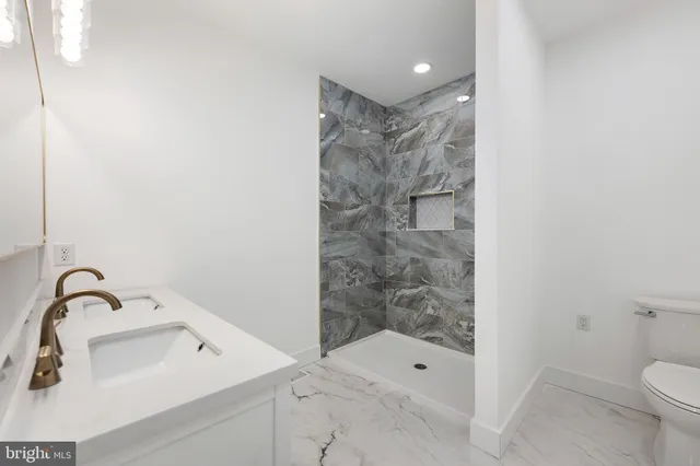 a bathroom with a toilet a sink and a mirror