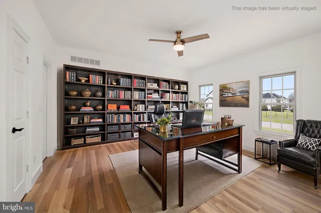 a view of room with a ceiling fan and windows